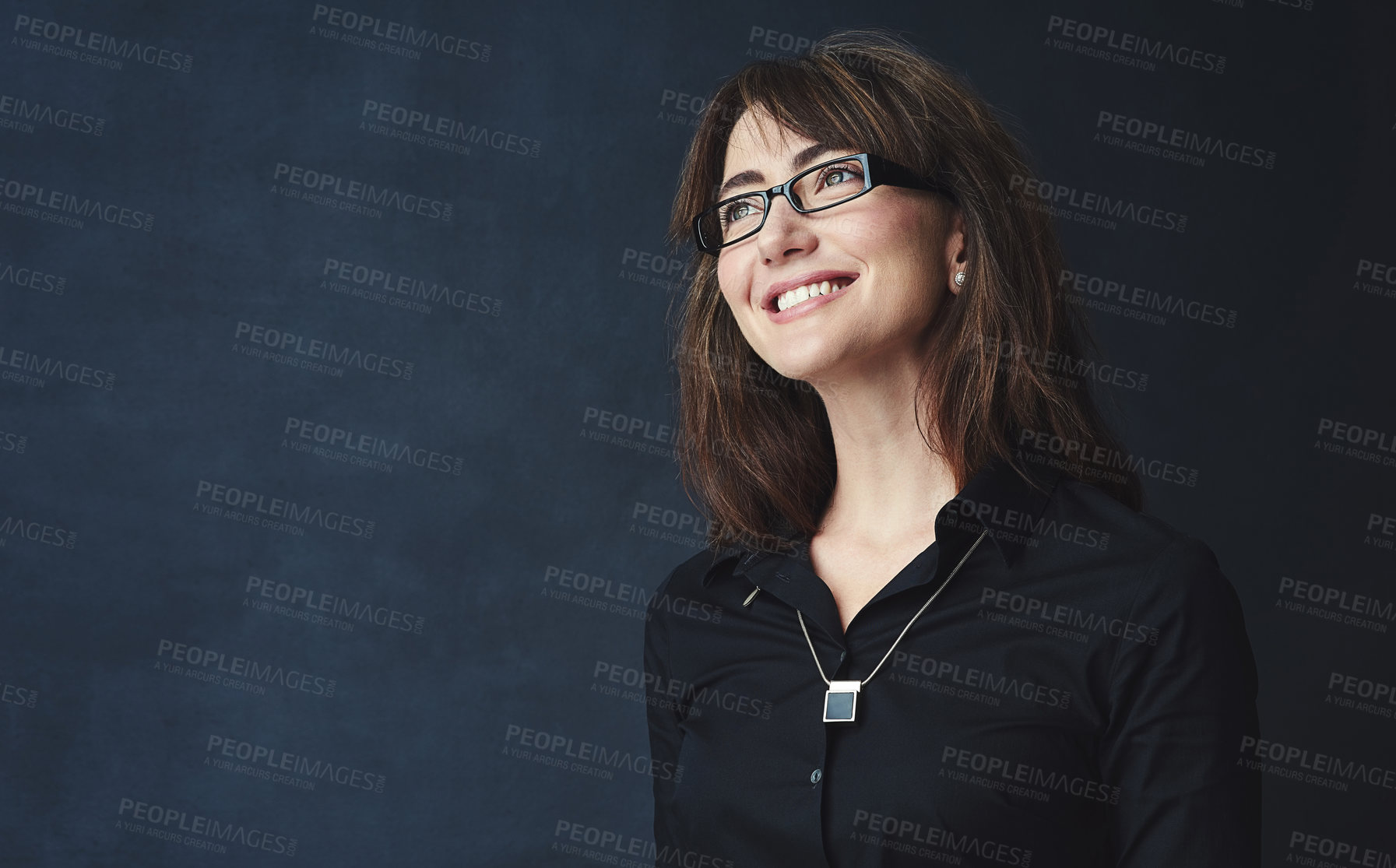 Buy stock photo Studio shot of a corporate businesswoman looking thoughtful against a dark background