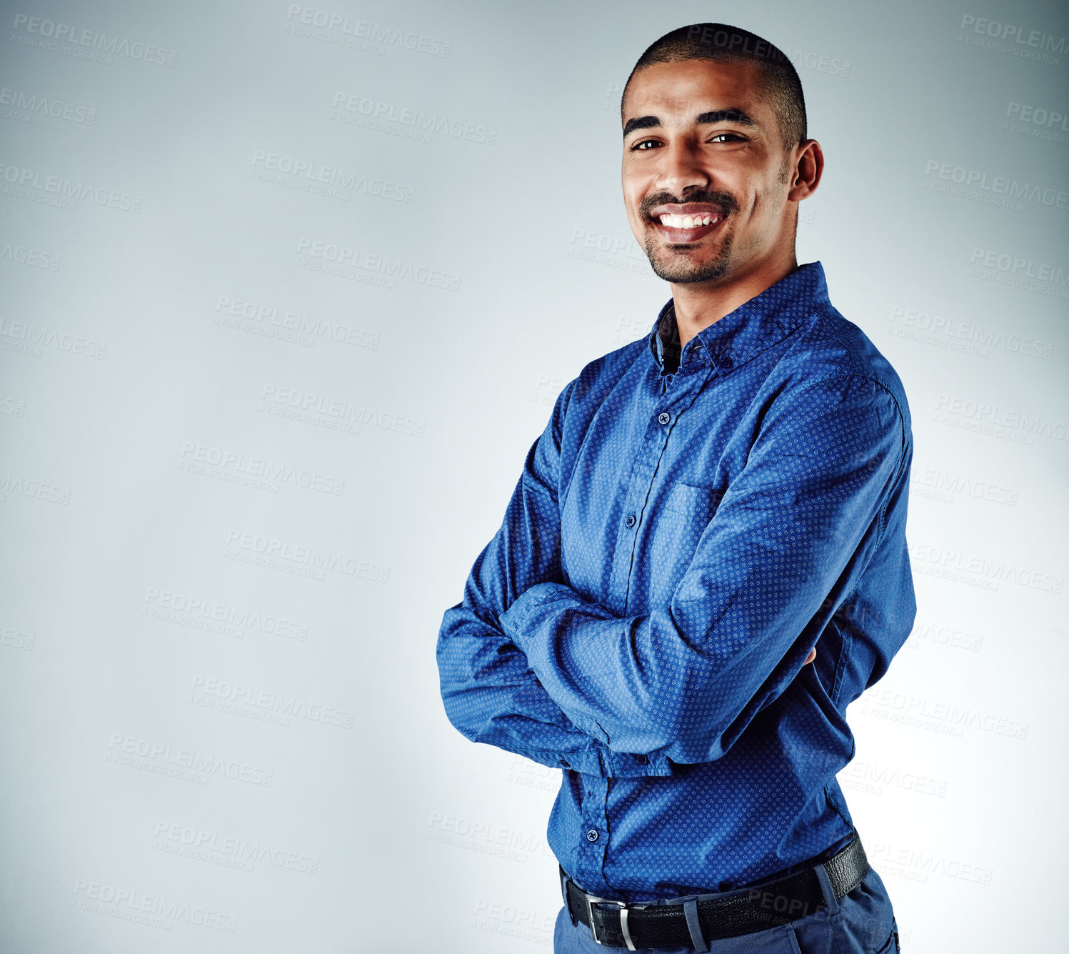 Buy stock photo Cropped shot of a young businessman posing against a grey background