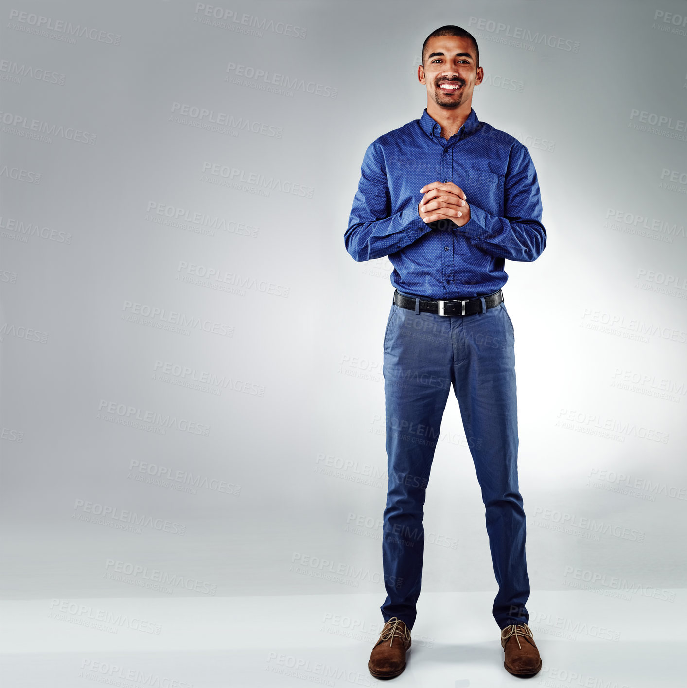 Buy stock photo Shot of a young businessman posing against a grey background