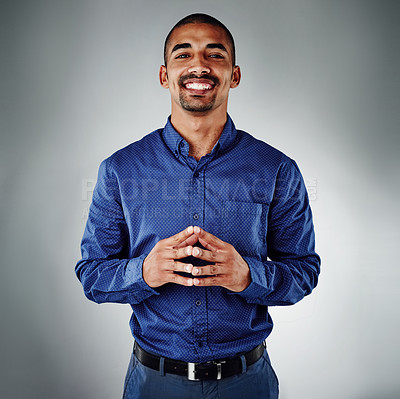 Buy stock photo Cropped shot of a young businessman posing against a grey background