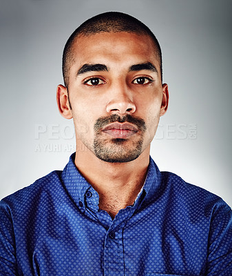 Buy stock photo Cropped shot of a young businessman posing against a grey background