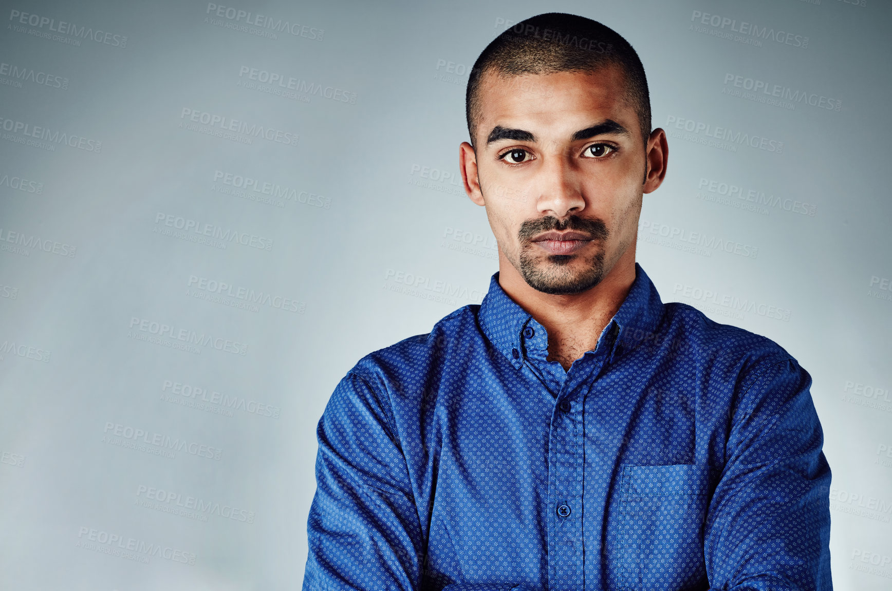 Buy stock photo Cropped shot of a young businessman posing against a grey background