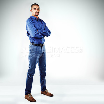 Buy stock photo Shot of a young businessman posing against a grey background