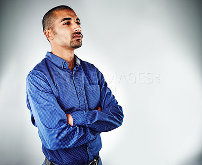 Buy stock photo Cropped shot of a young businessman posing against a grey background