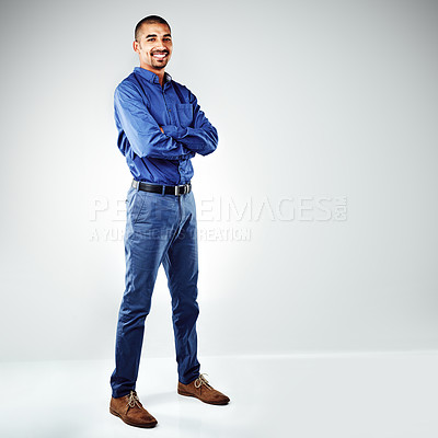 Buy stock photo Shot of a young businessman posing against a grey background