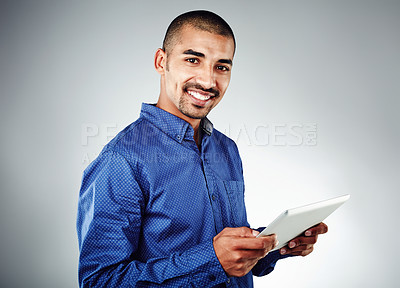 Buy stock photo Studio shot of a young businessman using his cellphone against a grey background