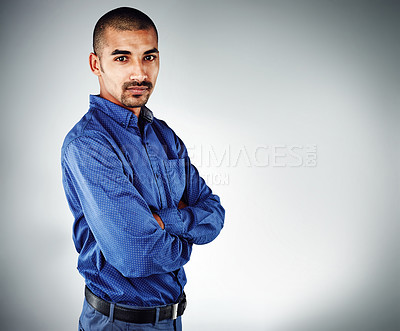 Buy stock photo Cropped shot of a young businessman posing against a grey background