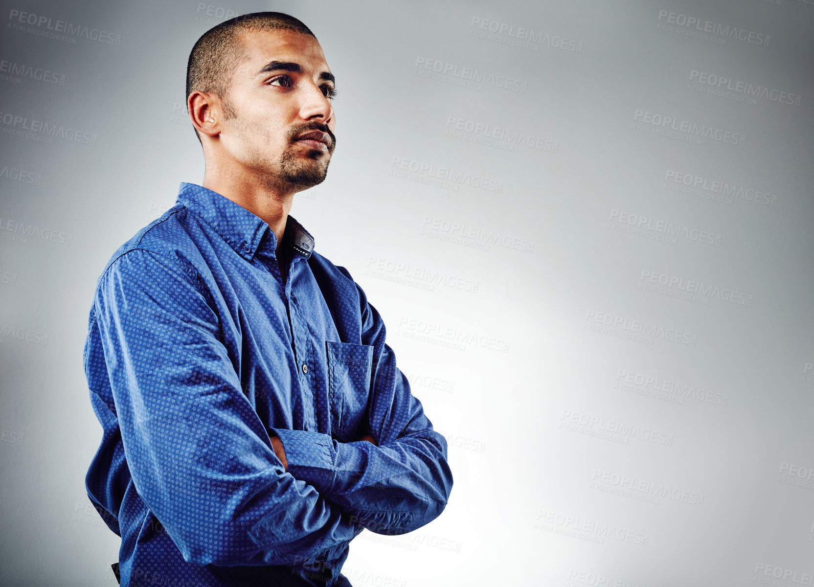 Buy stock photo Cropped shot of a young businessman posing against a grey background