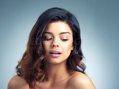 Buy stock photo Studio, calm and woman for hair care, makeup and maintenance of shiny curls. Female model, benefits and results of texture treatment for hairstyle, beauty and keratin for growth by blue background