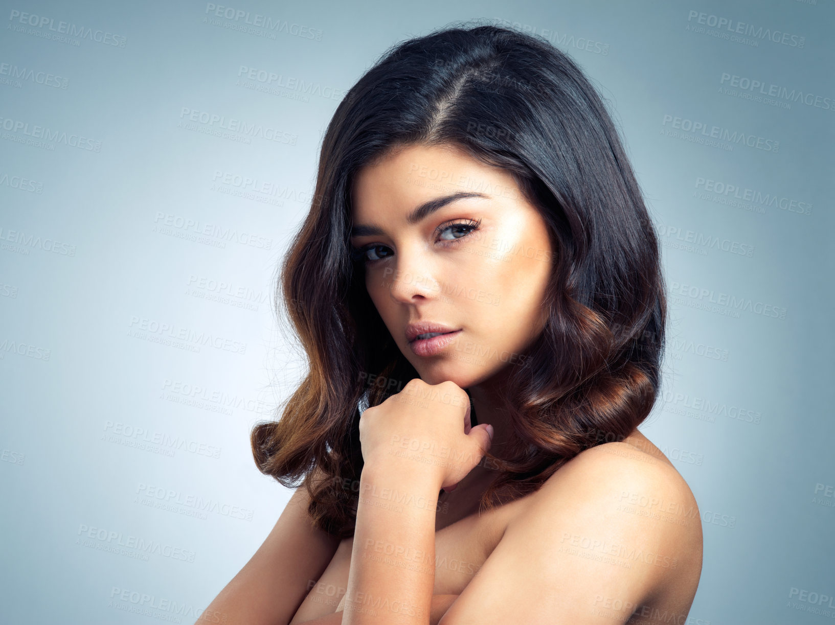 Buy stock photo Studio portrait of a beautiful young woman posing against a gray background