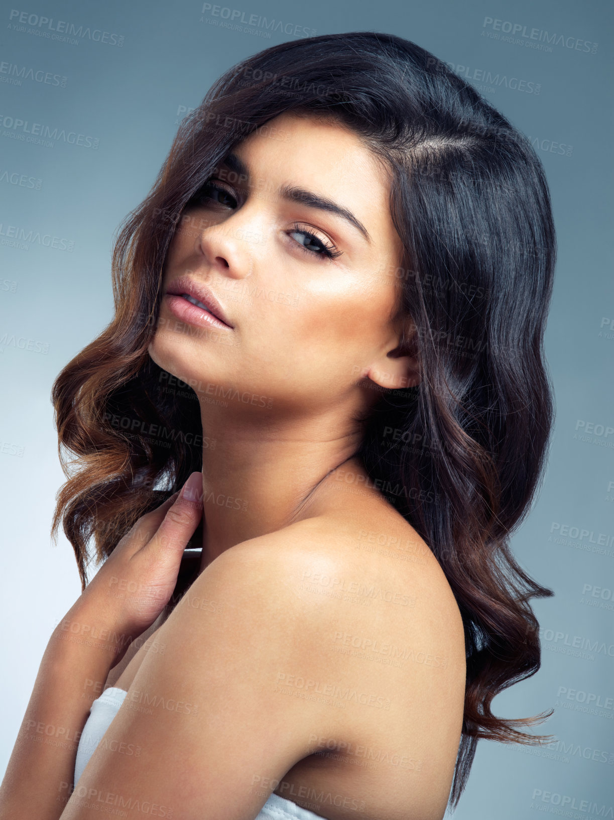 Buy stock photo Studio portrait of a beautiful young woman posing against a gray background