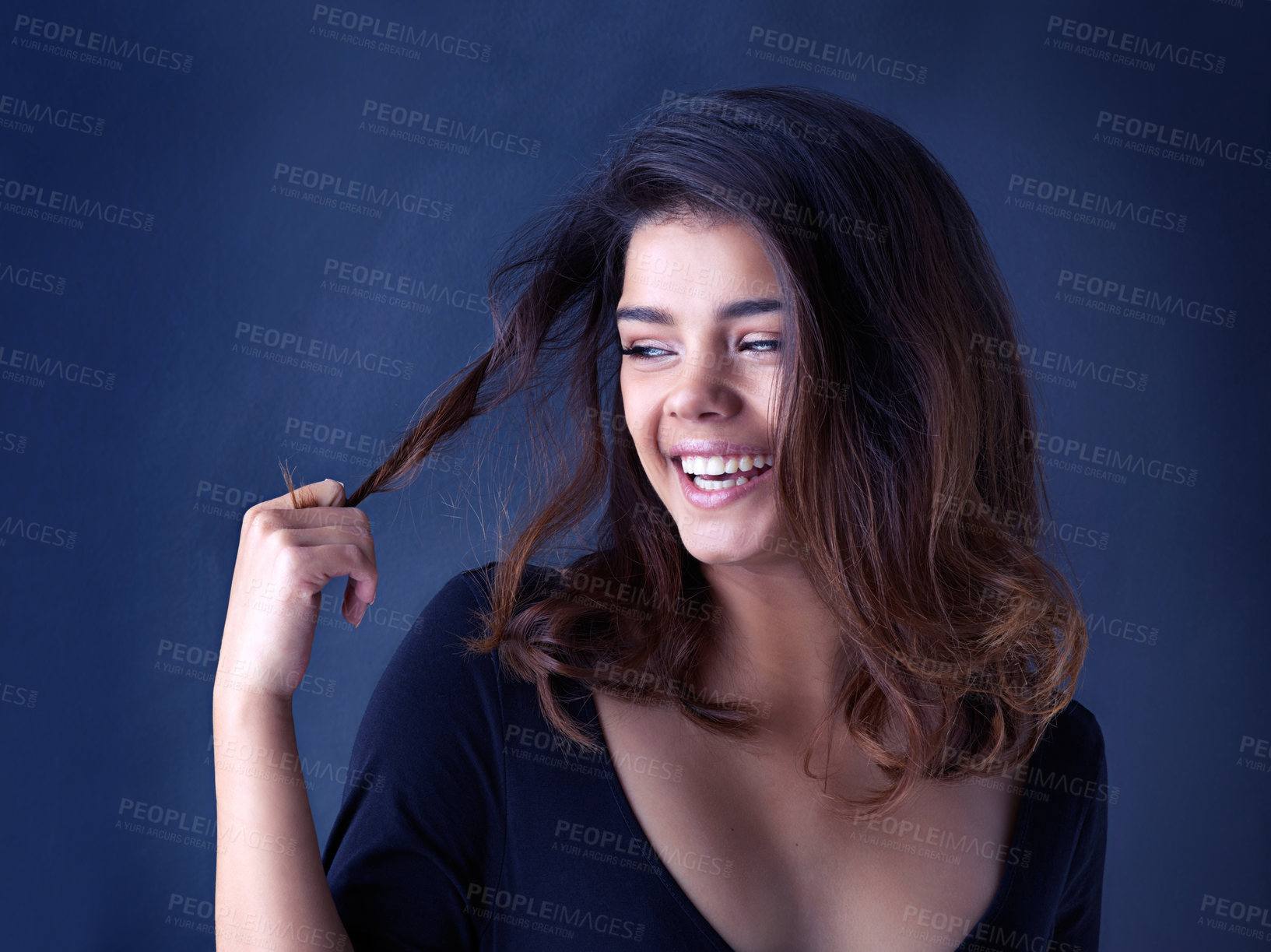 Buy stock photo Hair, soft or laughing woman in studio for cosmetic, shine and shampoo results on blue background. Haircare, beauty and gen z model with smooth, texture or growth from scalp treatment or satisfaction