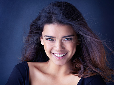 Buy stock photo Beauty, portrait and happy woman in studio for hair, shine or shampoo cosmetics, treatment or results on blue background. Makeup, wellness and face of gen z model with haircare, texture or smile