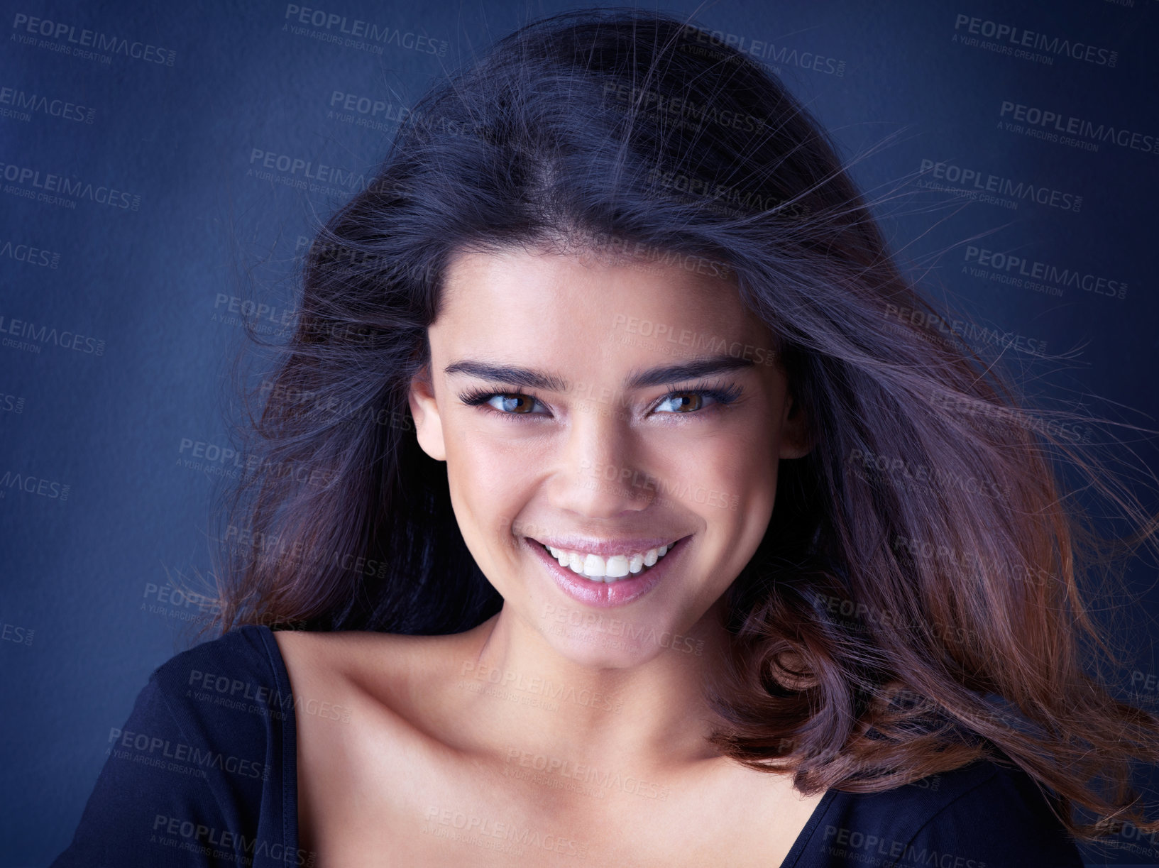 Buy stock photo Beauty, portrait and happy woman in studio for hair, shine or shampoo cosmetics, treatment or results on blue background. Makeup, wellness and face of gen z model with haircare, texture or smile