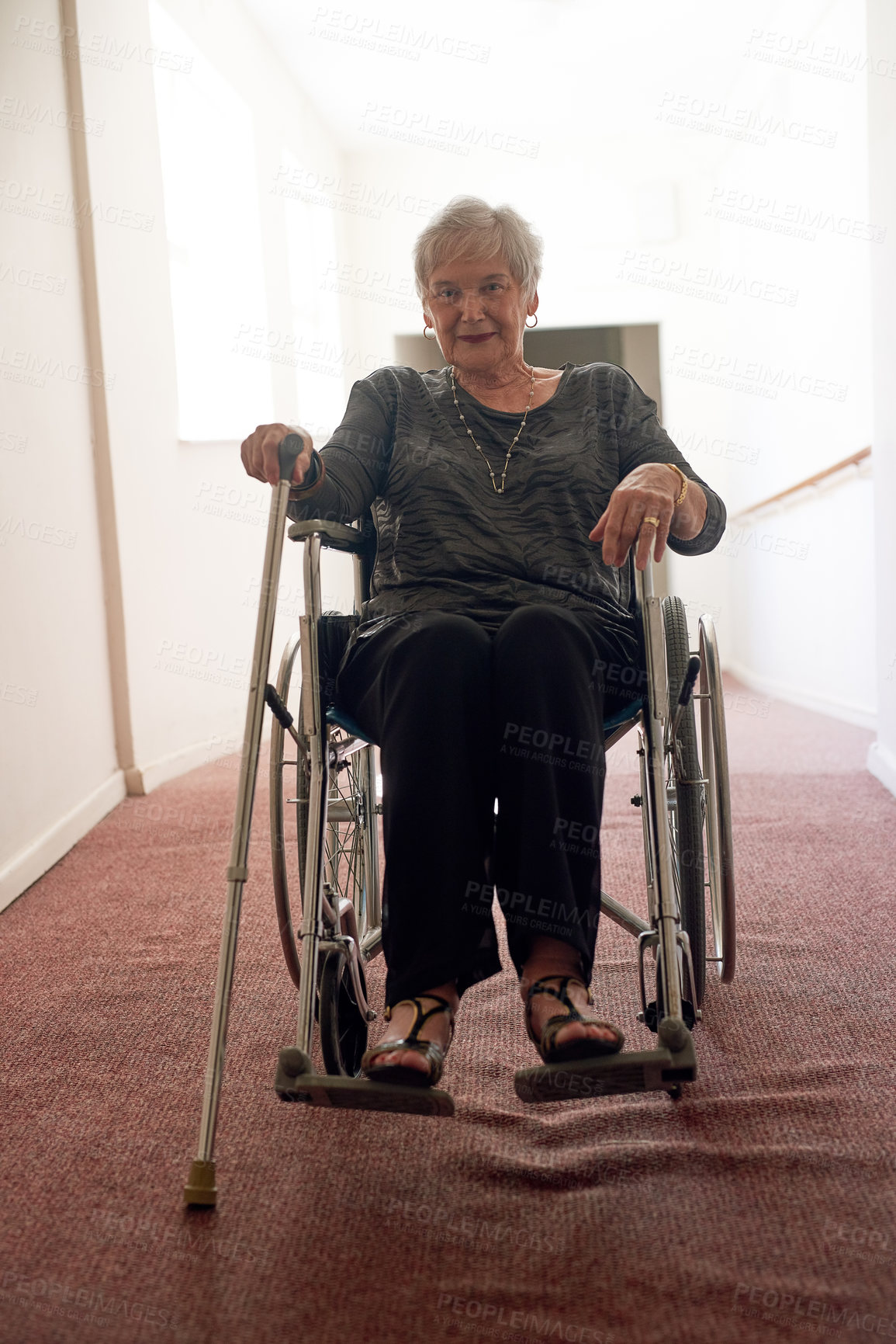 Buy stock photo Portrait, wheelchair and senior woman in corridor with disability, retirement and smile in nursing home. Elderly person, walking stick or accessories in hallway for memories, physical therapy or care