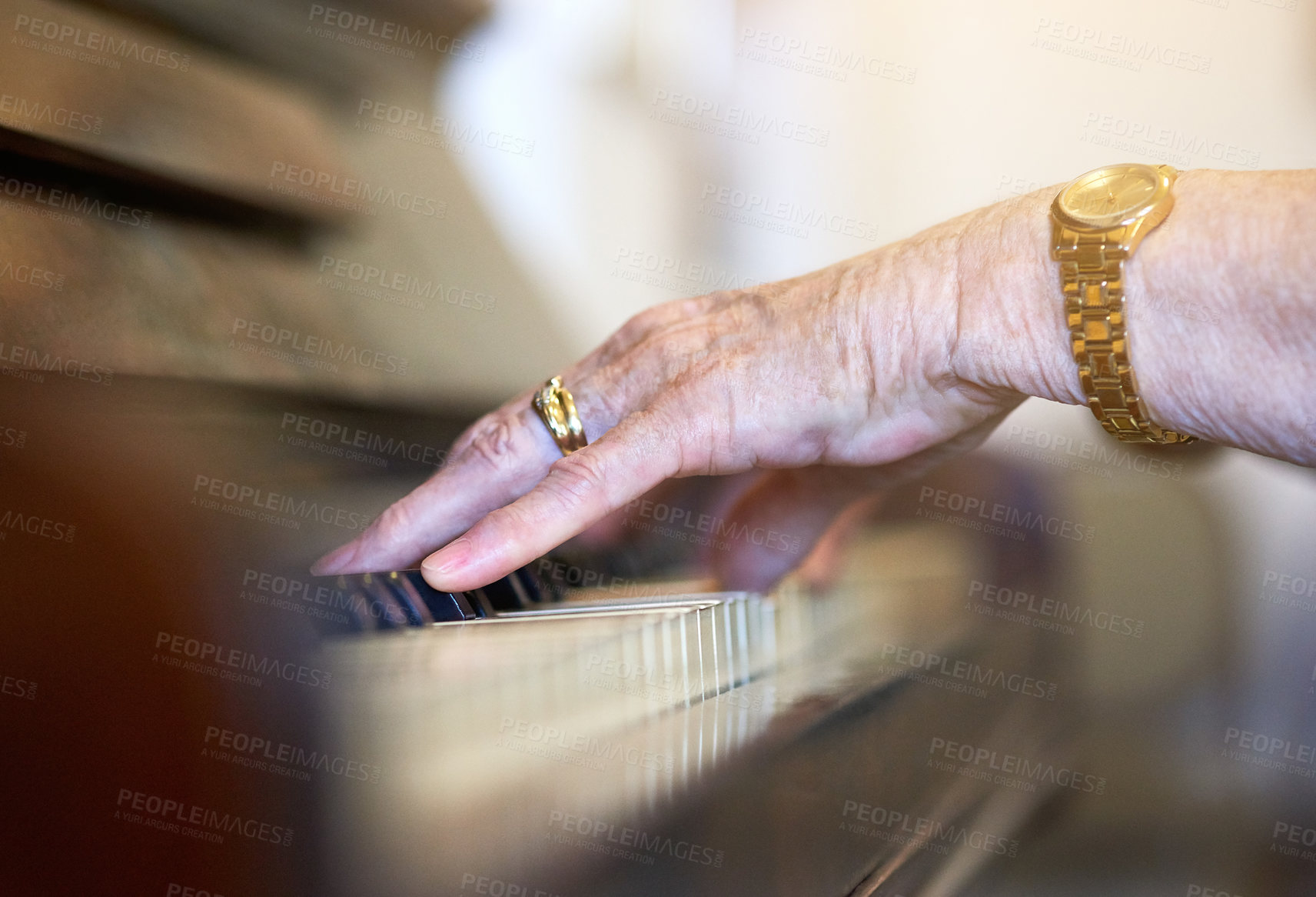 Buy stock photo Shot of an unidentifiable senior woman playing the piano at home