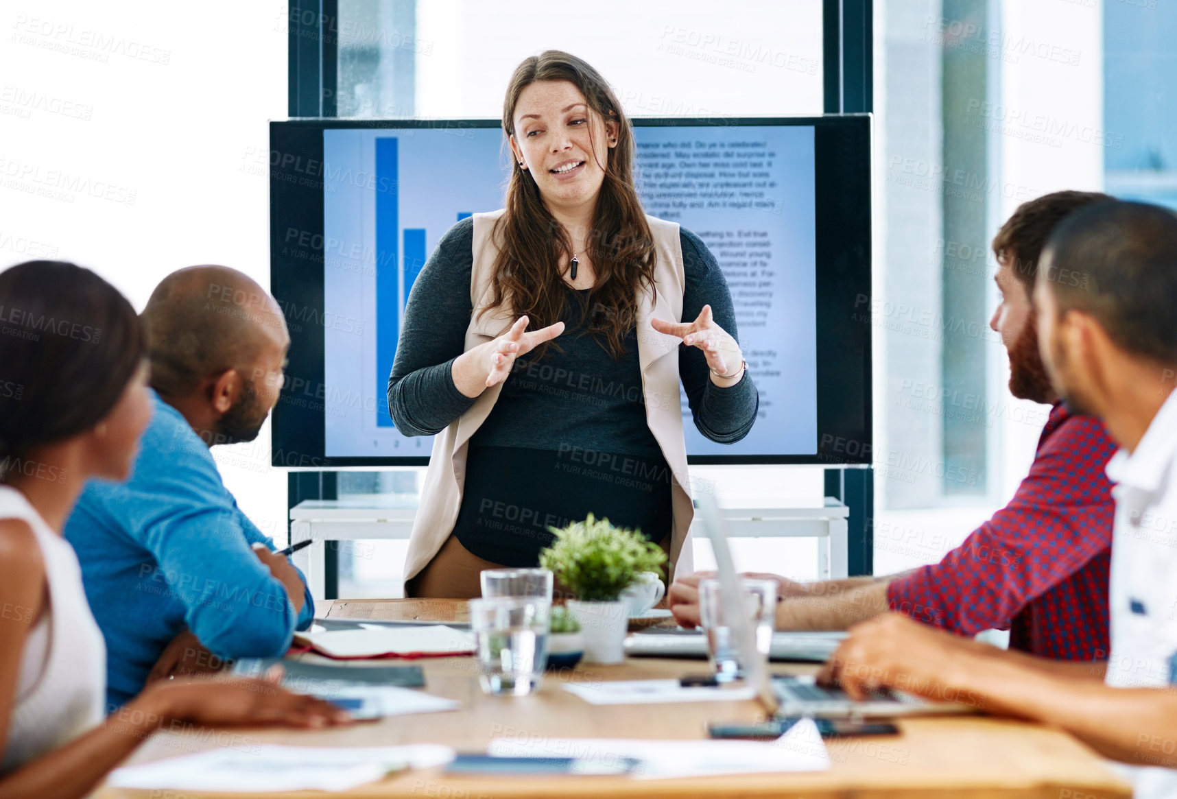 Buy stock photo Cropped shot of a young female designer giving a presentation in the boardroom