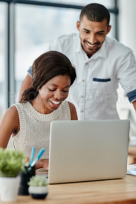 Buy stock photo Cropped shot of a young man helping a female colleague with something at her desk