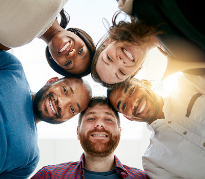 Buy stock photo Low angle portrait of a young design team standing in a huddle in their office
