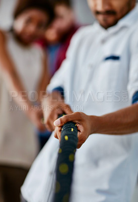 Buy stock photo Cropped shot of a group of young designers pulling on a rope during tug of war
