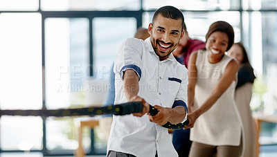 Buy stock photo Cropped shot of a group of young designers pulling on a rope during tug of war