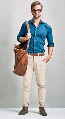 Buy stock photo Full length portrait of a handsome young man posing with a bag in the studio