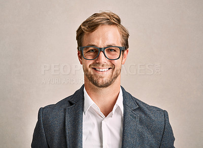 Buy stock photo Cropped portrait of a handsome young man in a suit posing in the studio