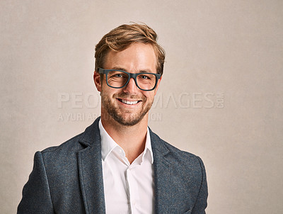 Buy stock photo Cropped portrait of a handsome young man in a suit posing in the studio