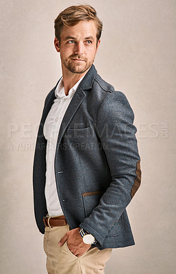 Buy stock photo Cropped shot of a handsome young man in a suit posing in the studio