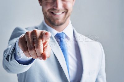 Buy stock photo Studio shot of a businessman in a grey suit posing against a grey background