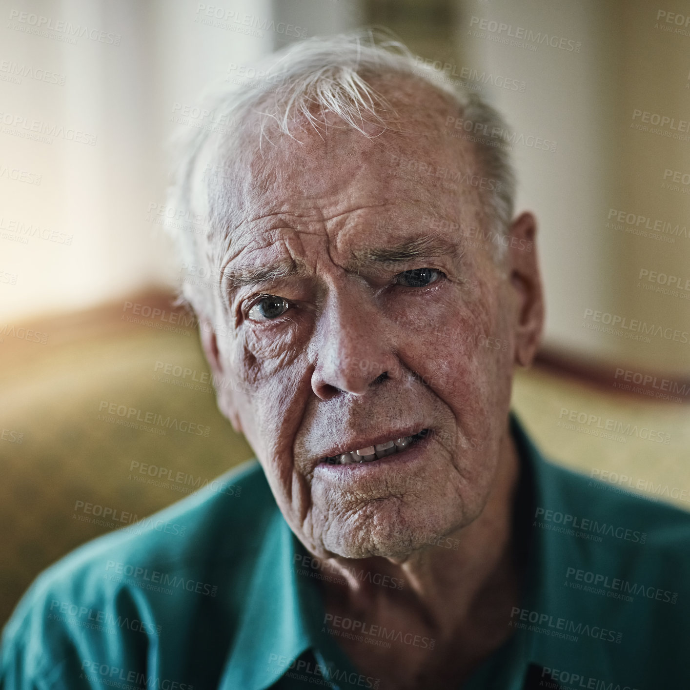 Buy stock photo Cropped shot of a senior man sitting by himself in a living room