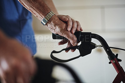 Buy stock photo Shot of a female nurse assisting her senior patient who's using a walker for support