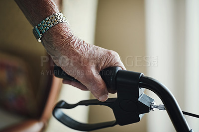 Buy stock photo Cropped shot of a senior man holding on to his walker