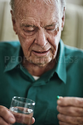 Buy stock photo Cropped shot of a senior man about to take his medication