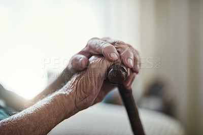 Buy stock photo Cropped shot of an unrecognizable man leaning on his walking stick