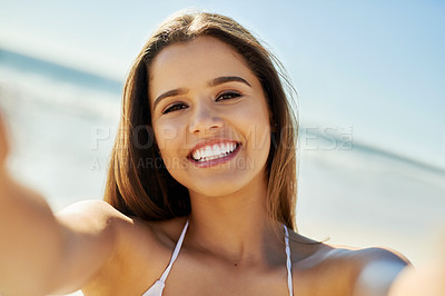 Buy stock photo Shot of a young woman taking a selfie whilem