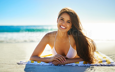 Buy stock photo Portrait of a beautiful young woman lying on the beach