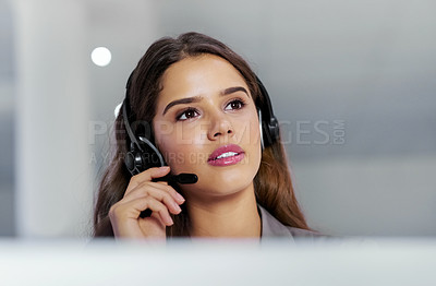 Buy stock photo Shot of a young call centre agent working in an office