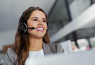 Buy stock photo Shot of a young call centre agent working in an office