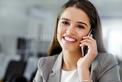 Buy stock photo Portrait of a young businesswoman talking on a cellphone in an office