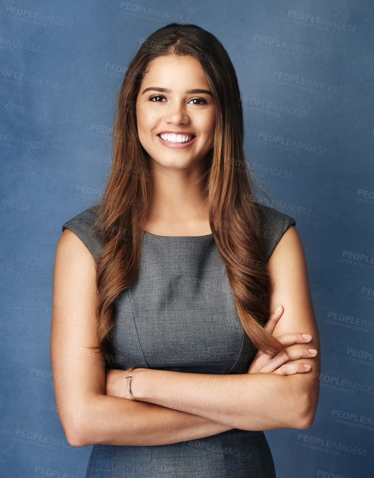 Buy stock photo Studio portrait of a confident young businesswoman posing against a grey background