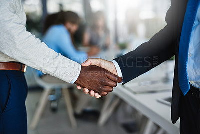 Buy stock photo Cropped shot of two businessmen shaking hands during a meeting at work