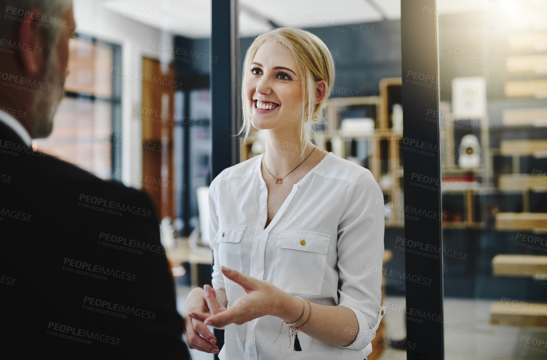 Buy stock photo Cropped shot of two businesspeople talking while standing in the office