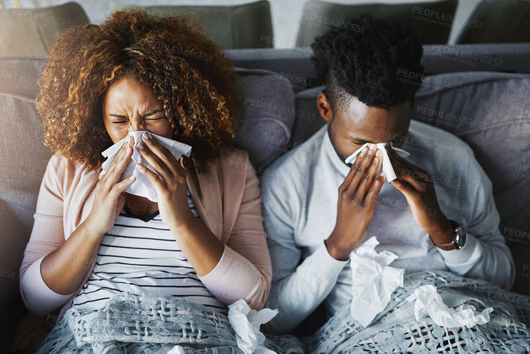 Buy stock photo Sick couple, sneeze and blowing nose with tissue on sofa for allergy, virus or flu and cold together above at home. Top view, young man and woman with influenza for sinus, symptoms or fever season