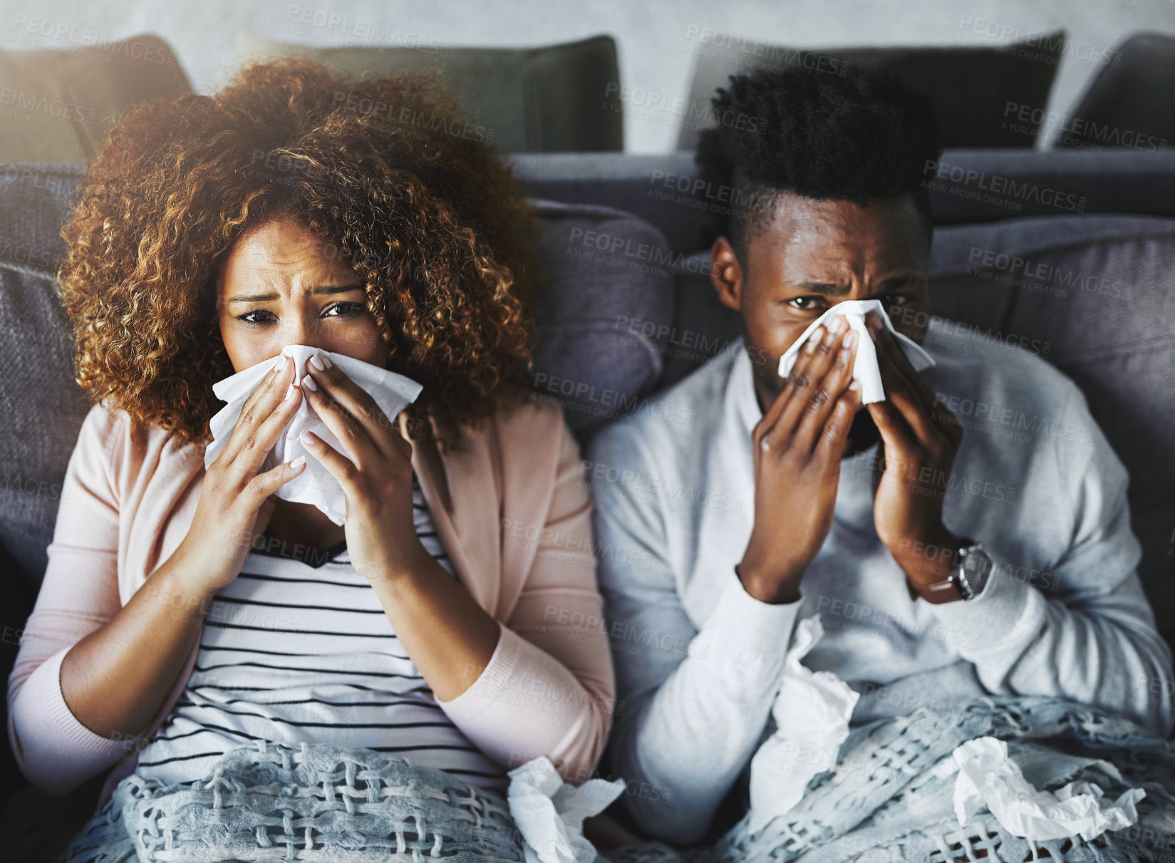 Buy stock photo Portrait of a sick couple suffering from the flu, corona or sinus at home together, feeling unwell and weak. Girlfriend and boyfriend in quarantine, recovering from a virus and resting indoors