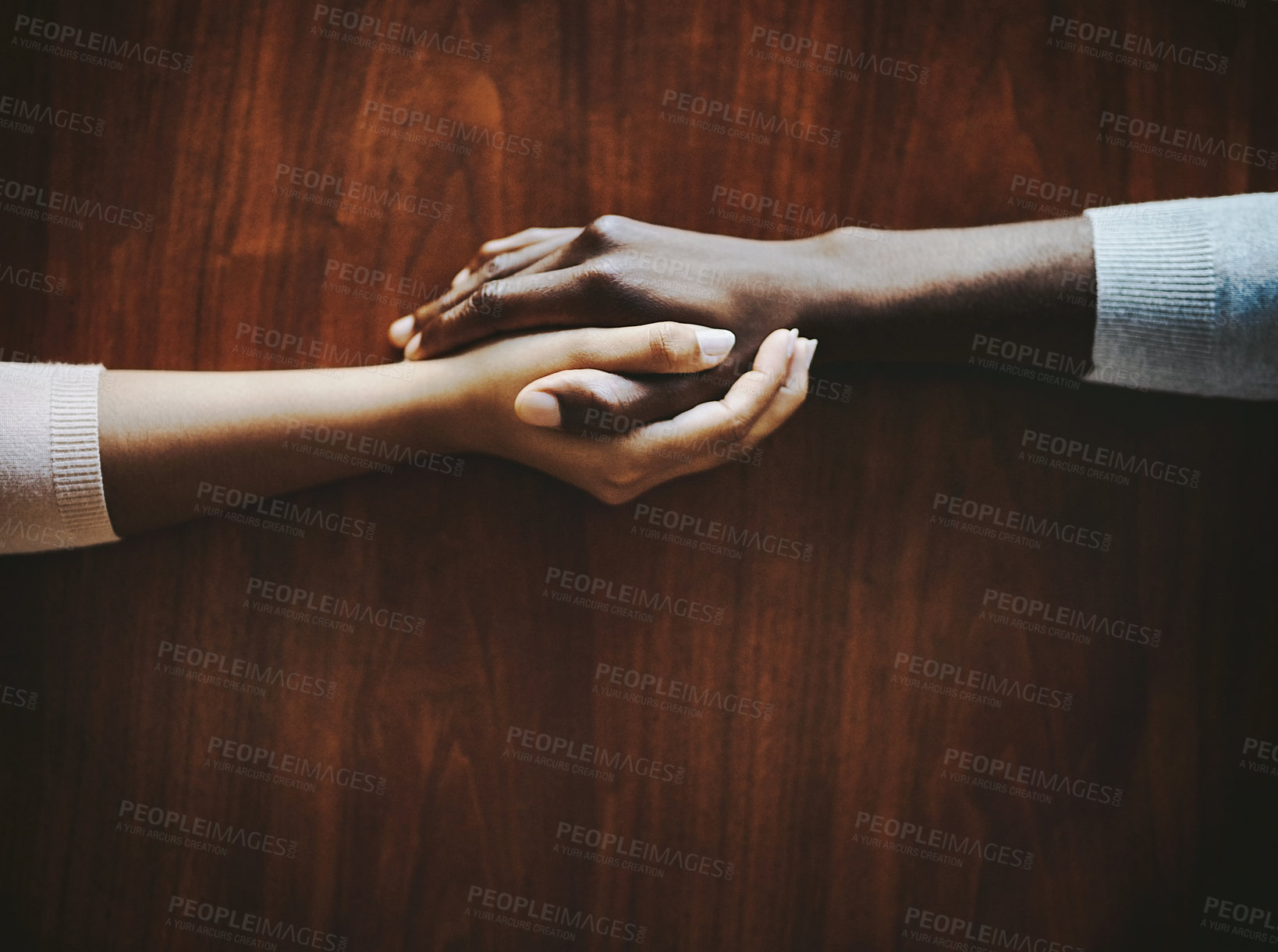 Buy stock photo High angle shot of two people holding hands in comfort
