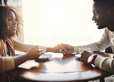 Buy stock photo Shot of an affectionate young couple on a date in a cafe