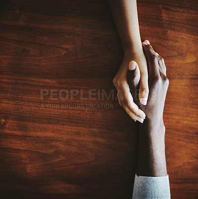 Buy stock photo High angle shot of two people holding hands in comfort