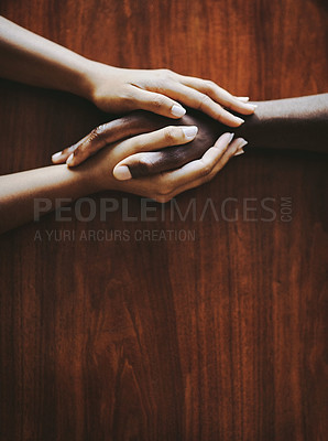 Buy stock photo Support, love and a couple holding hands at a table from above with copyspace. Interracial friends praying, consoling and showing care at therapy or after bad news. Unity and affection after grief.