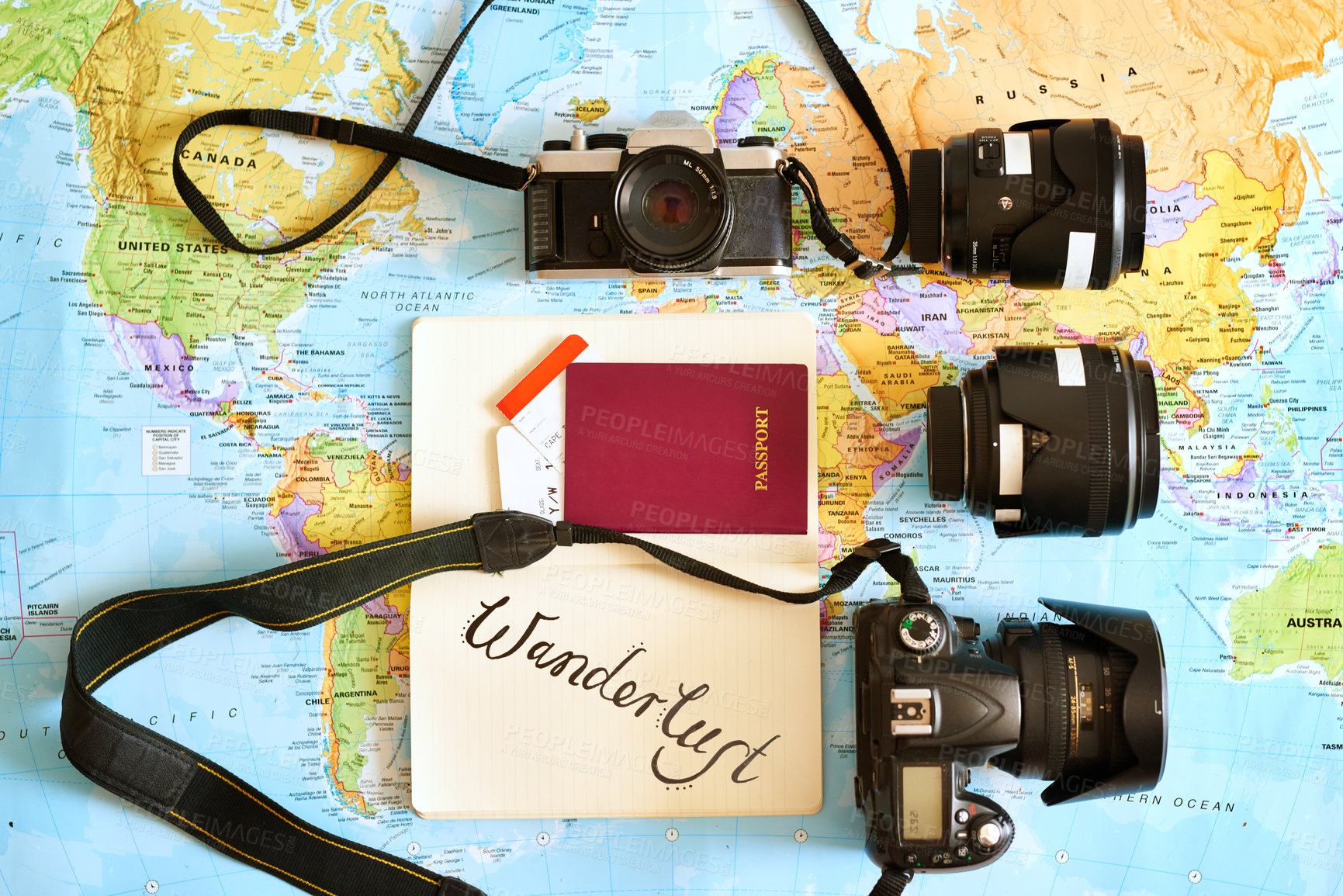 Buy stock photo High angle shot of a map with a passport and various cameras and lenses arranged on it